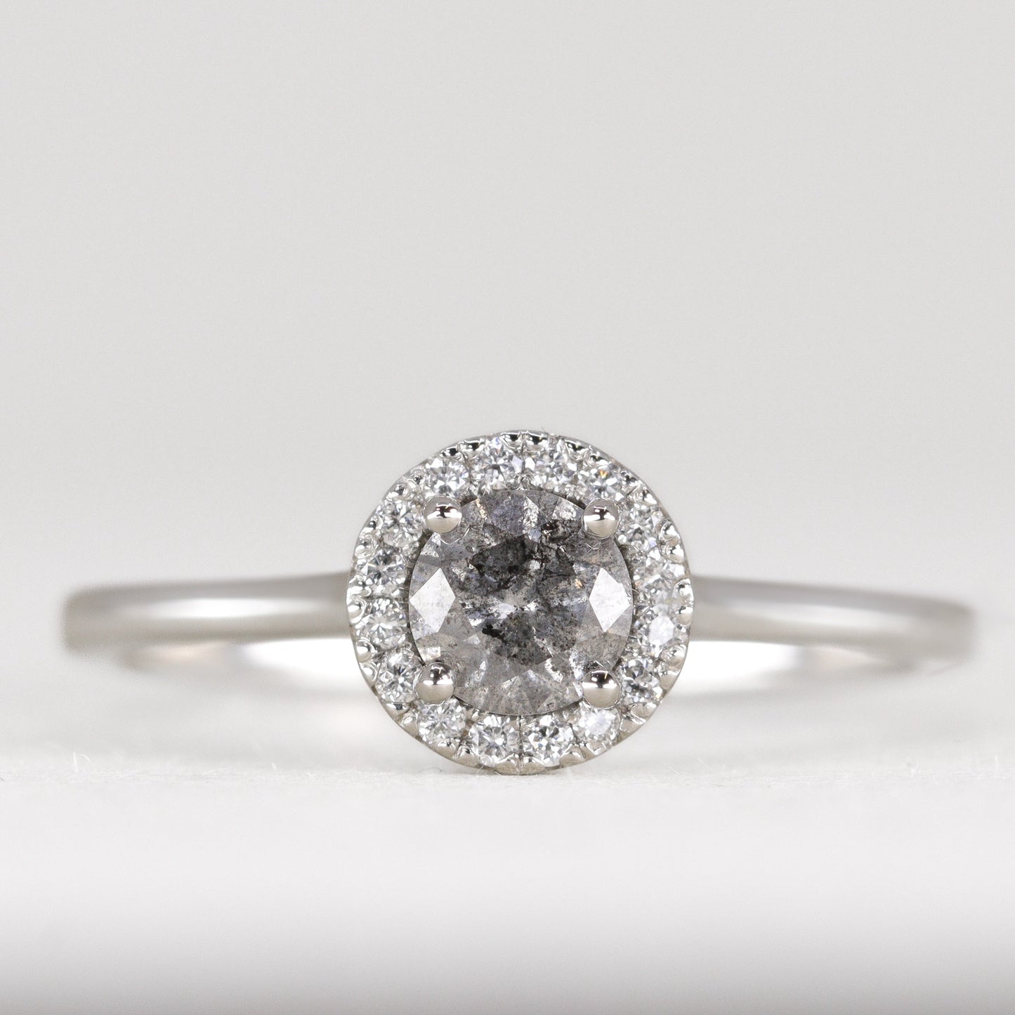 Salt and pepper diamond engagement ring with white diamond halo