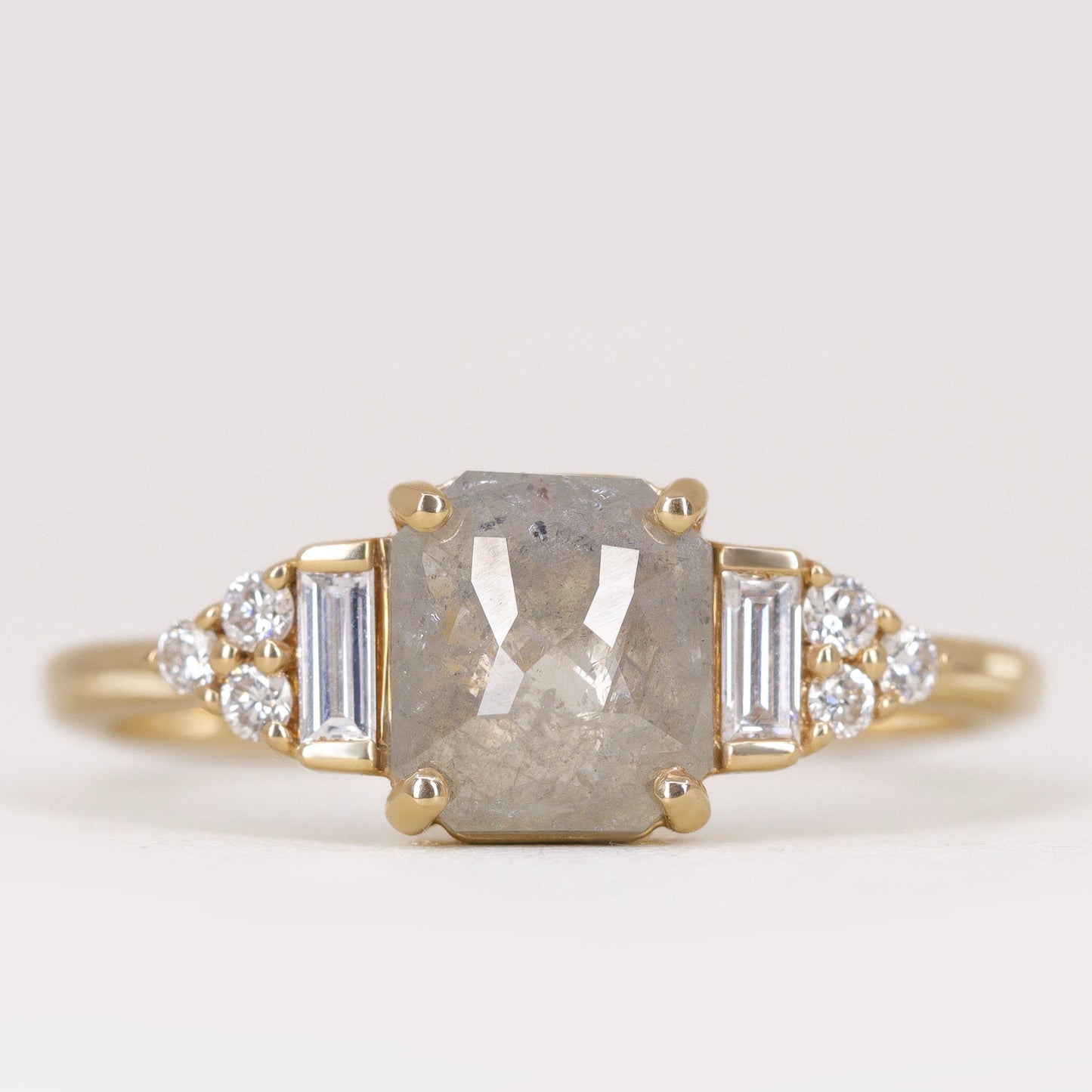 Art deco inspired yellow gold engagement ring with salt and pepper diamond and white diamond side stones