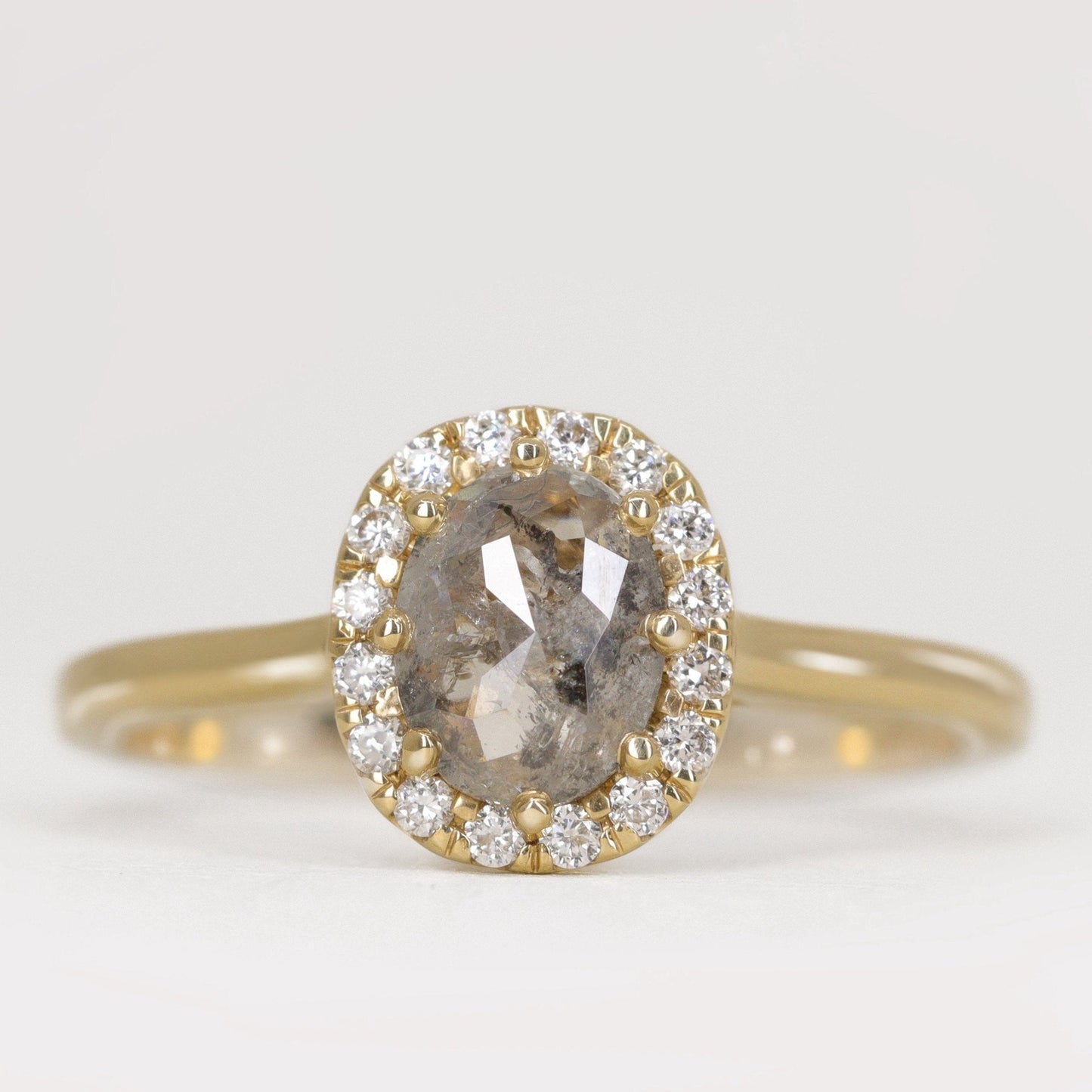 Oval cut salt and pepper diamond with white diamond halo engagement ring