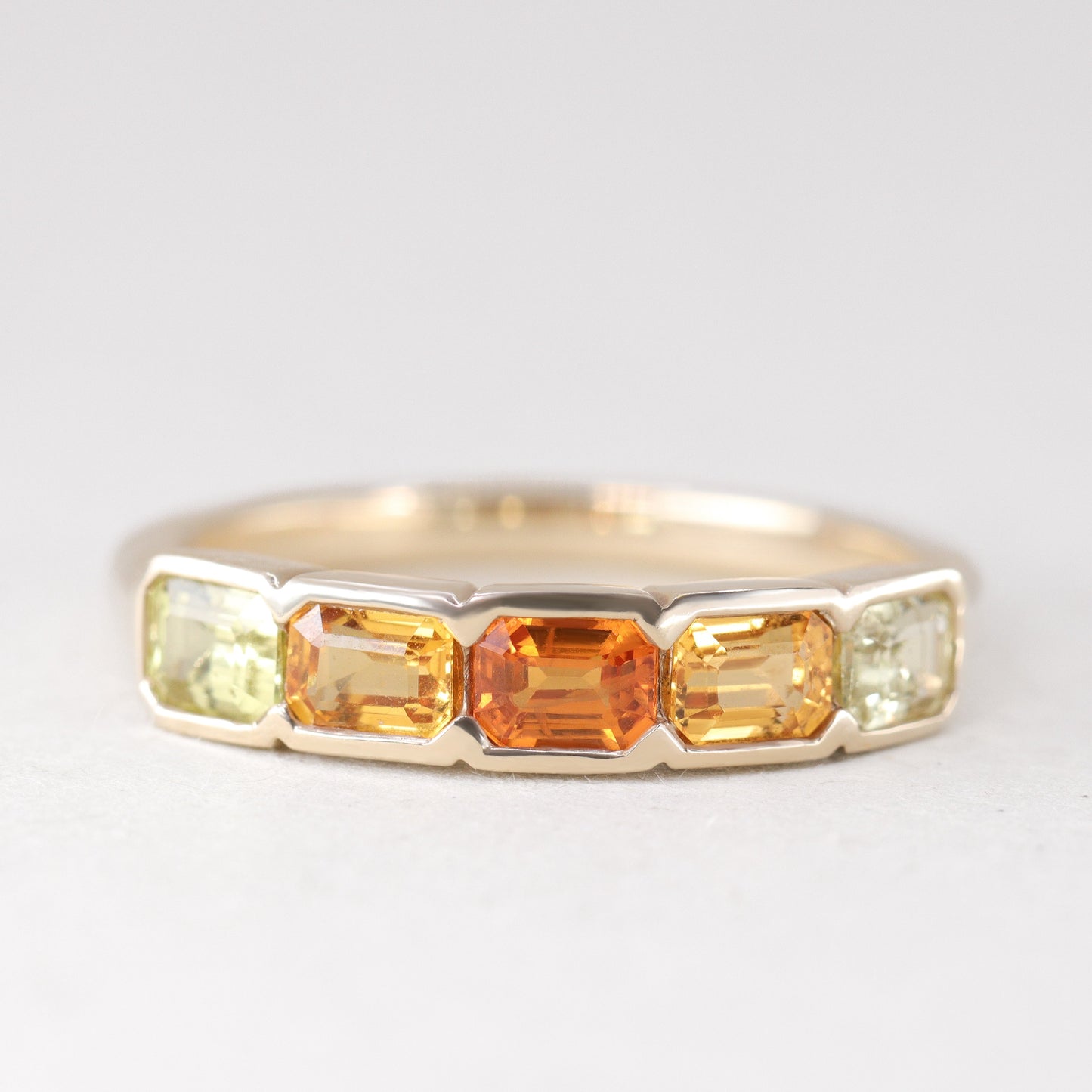 Half bezel rubover yellow and orange sapphire eternity stacking ring