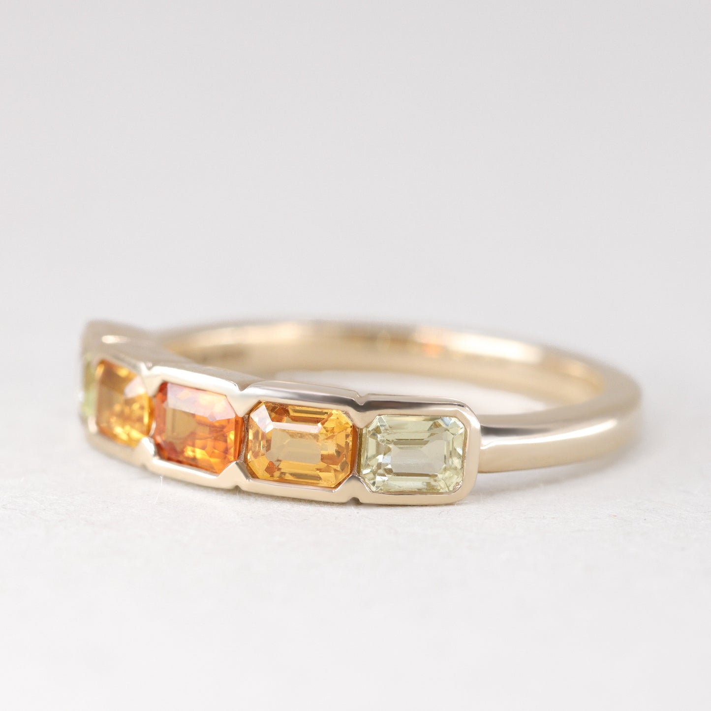 Half bezel rubover yellow and orange sapphire eternity stacking ring