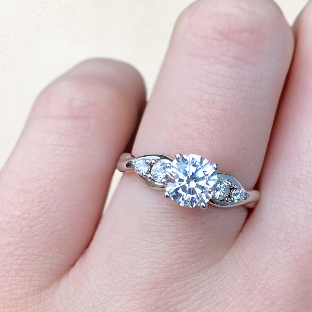 Round cut white diamond engagement ring with unique twisted platinum band
