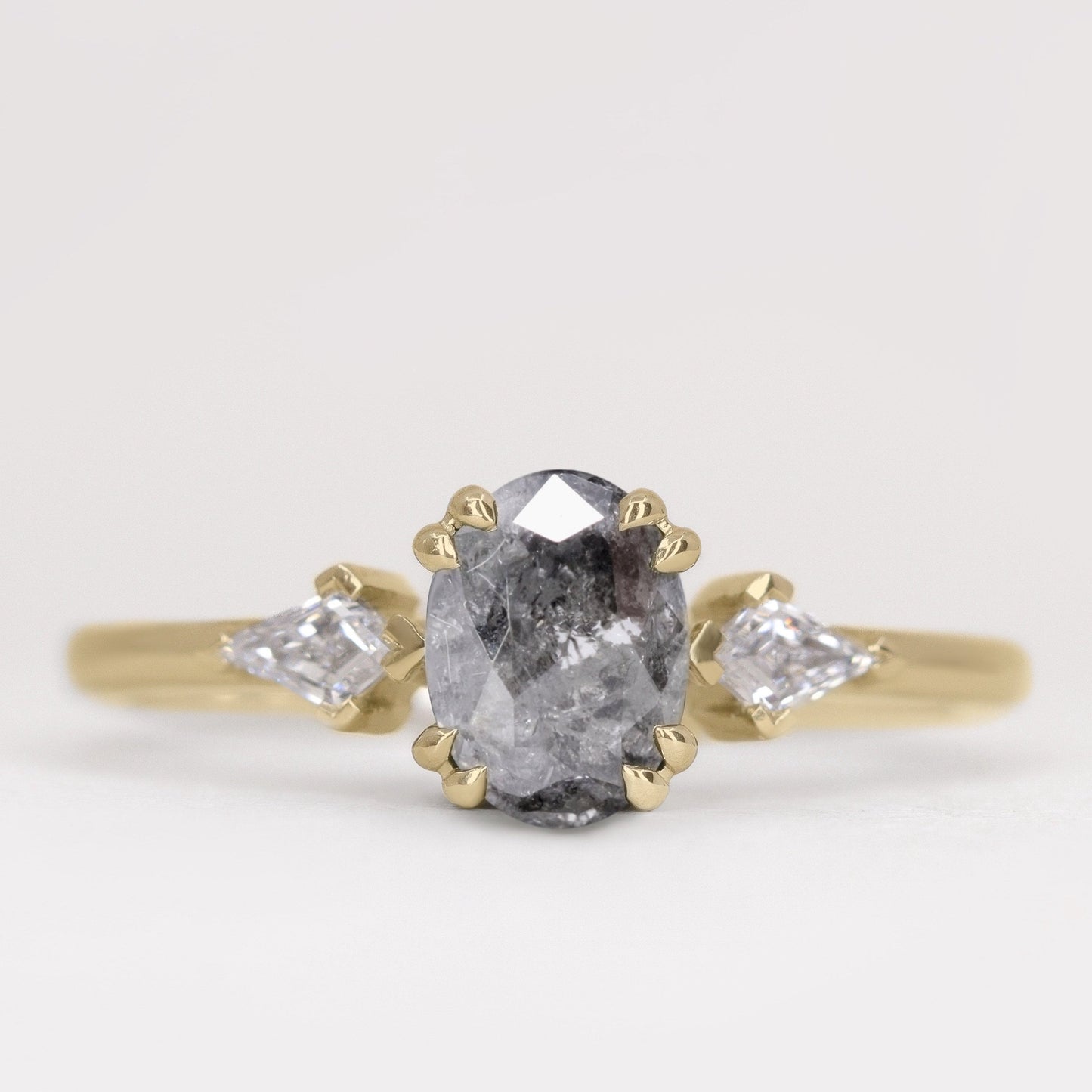 Oval salt and pepper diamond and white diamond trilogy engagement ring