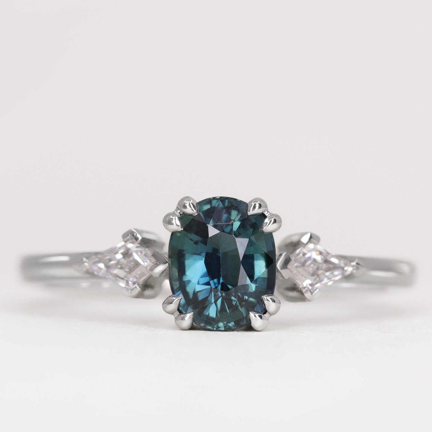 Oval cut teal sapphire ring with lab grown diamonds