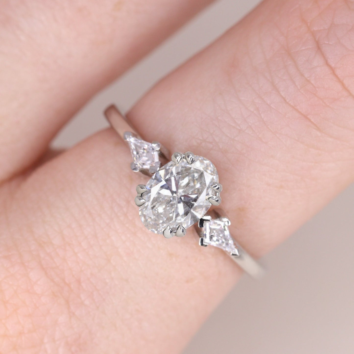 Oval and kite cut white diamond trilogy unique engagement ring