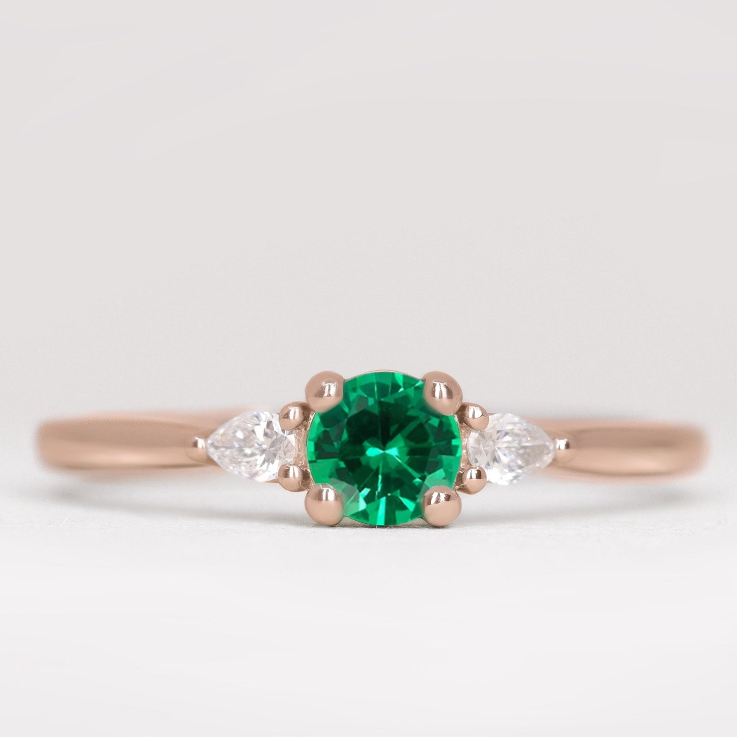 Unique engagement ring with emerald and lab grown diamonds