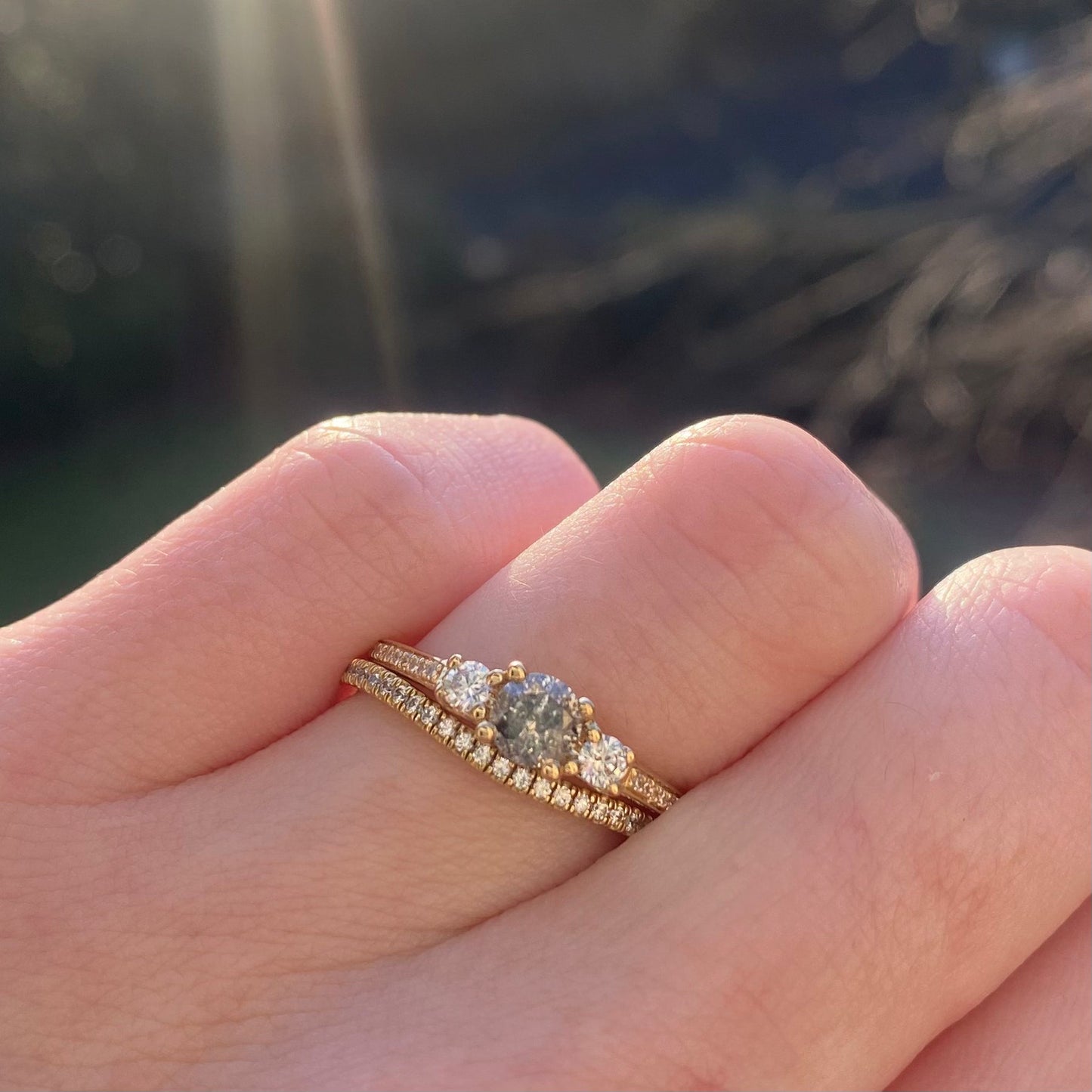 Round salt and pepper diamond and white diamond trilogy engagement ring with pave band