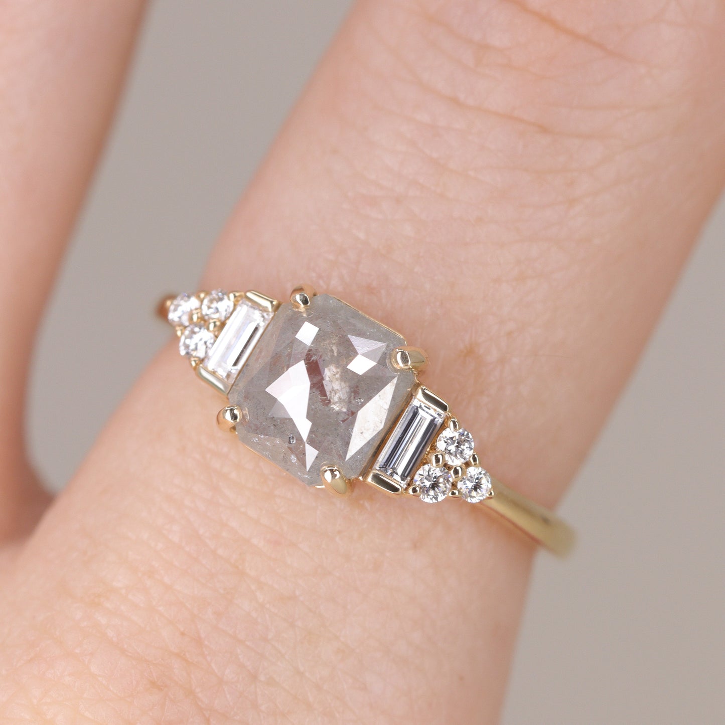 Art deco inspired yellow gold engagement ring with salt and pepper diamond and white diamond side stones