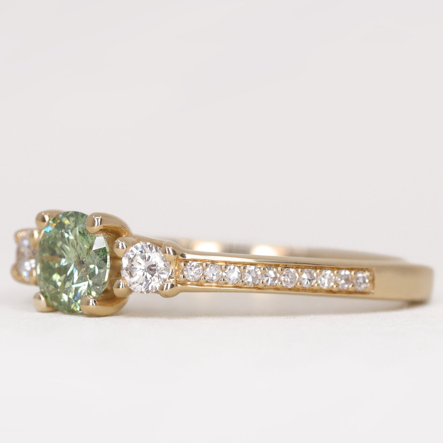 Round green diamond and white diamond pave  yellow gold band engagement ring