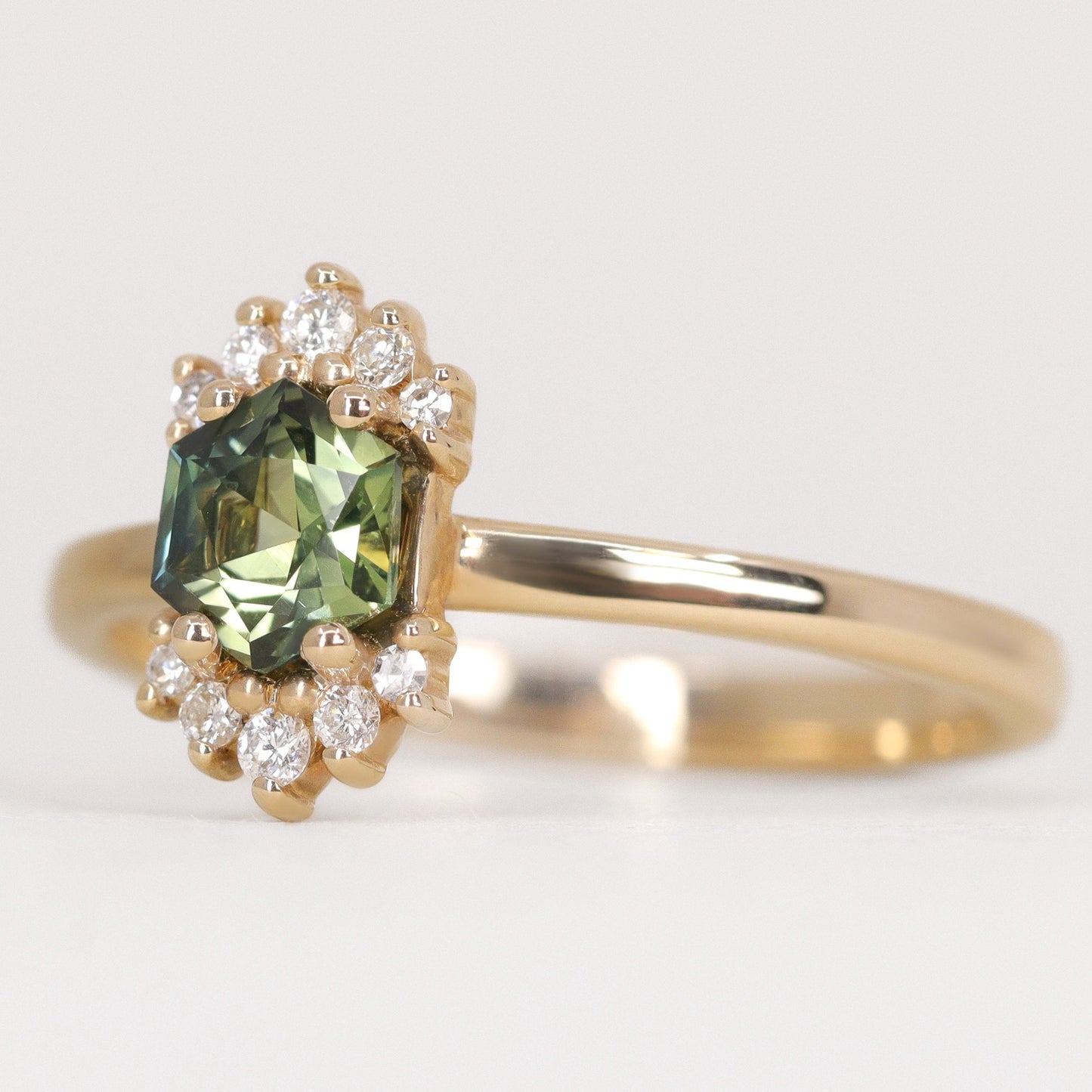 Unique hexagon cut green sapphire yellow gold engagement ring with white diamonds
