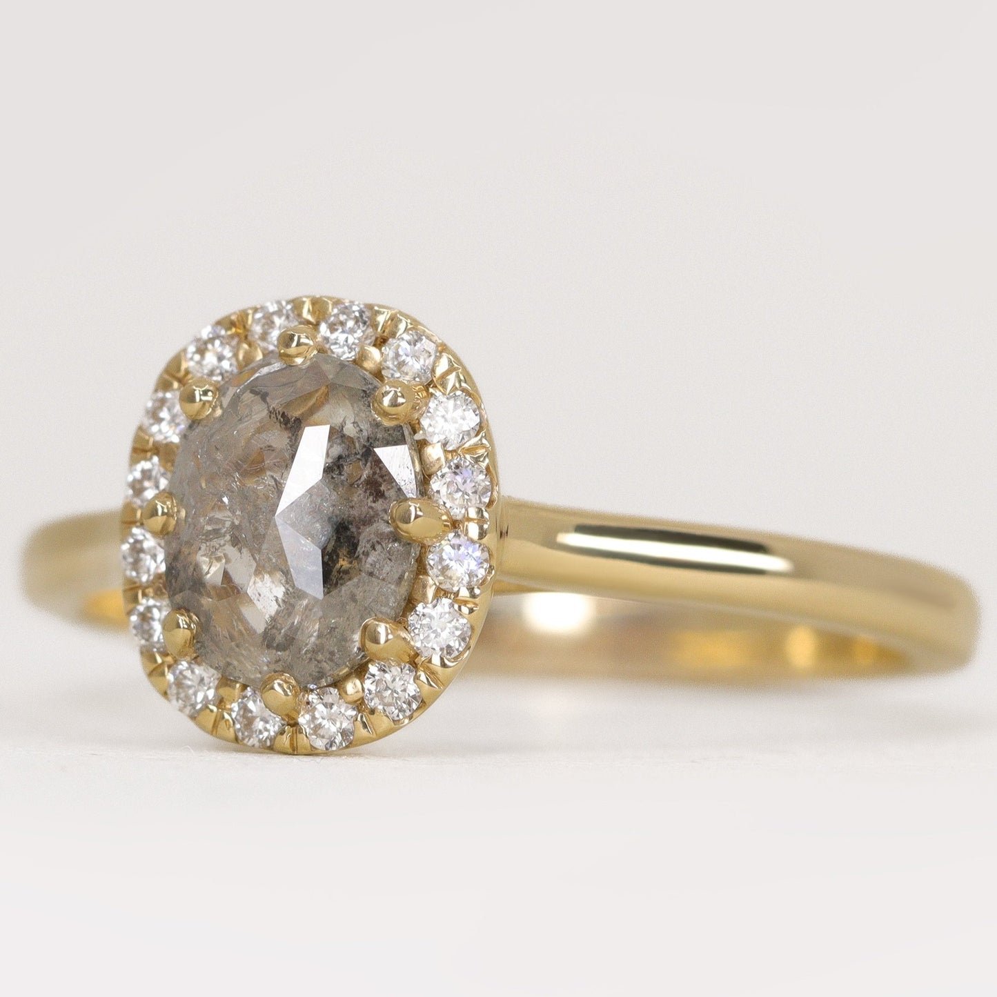 Oval cut salt and pepper diamond with white diamond halo engagement ring